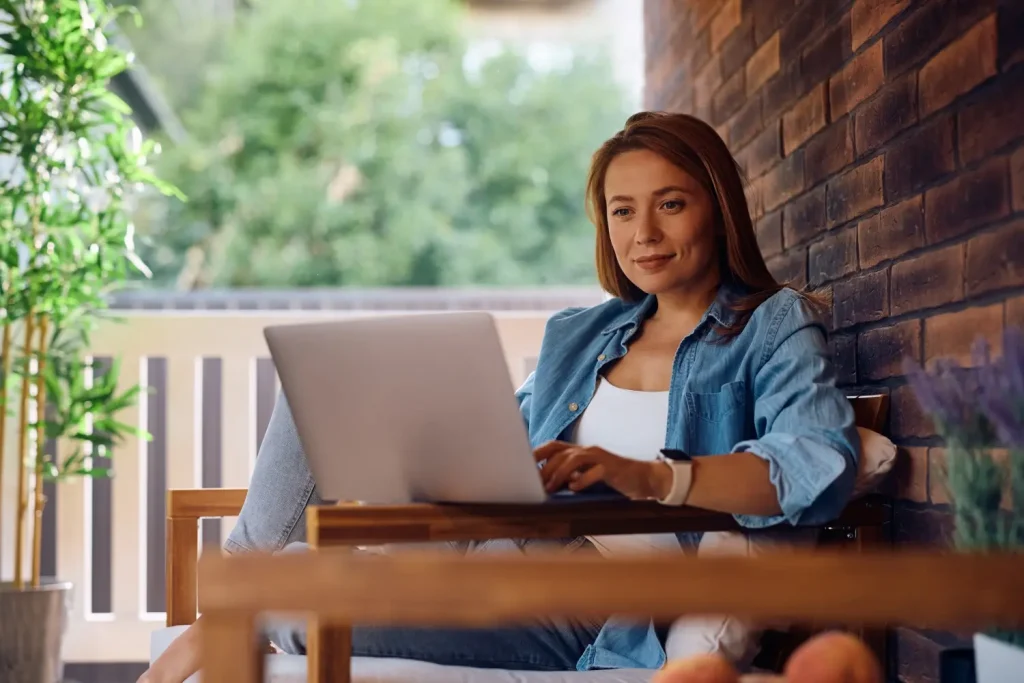 Woman using laptop to make NDIS referral