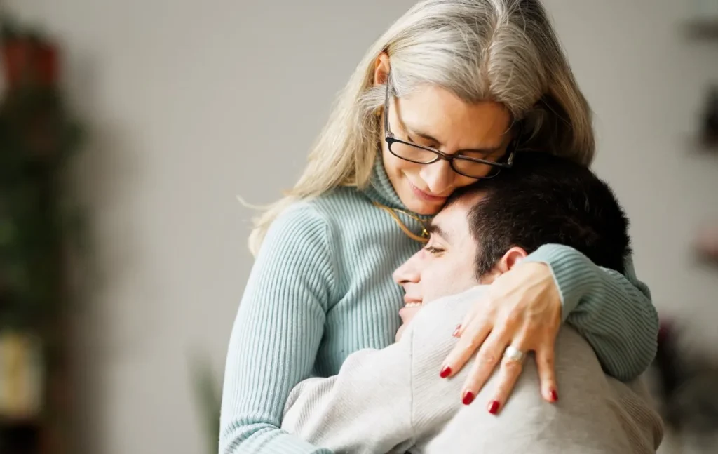 Mother hugging her disabled son